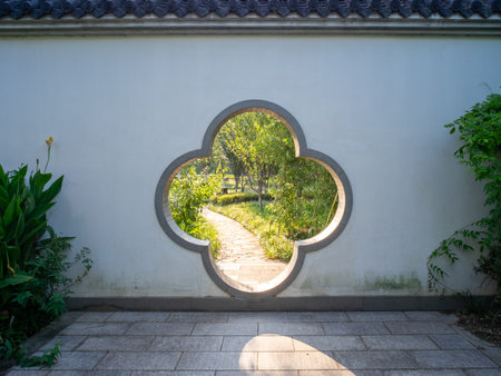 Garden view through a hole in the wall of a Chinese templeの写真素材