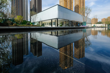 Description: A wide shot showing a flawless reflection of a modern glass building in a perfectly...