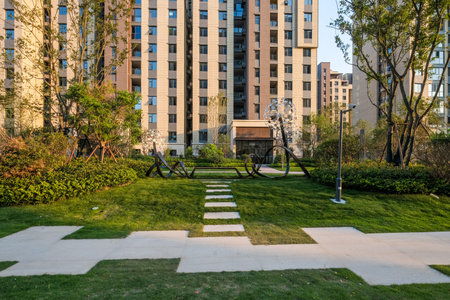 shangqiu, china - july 06, 2019: a green lawn with stepping stones in a residential complex in...