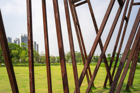 wuhan, china - may 16, 2016: an open community park with landscaped paths and abstract metallic art installations in wuhan, hubei province, china.の写真素材