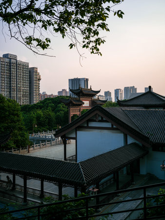 Wuhan, China - May 19, 2025: Elevated view of traditional Chinese buildings featuring white walls,...