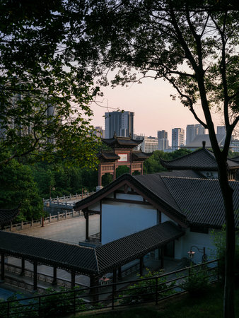 Wuhan, China - May 19, 2025: Elevated view of traditional Chinese covered walkways with dark tiled...