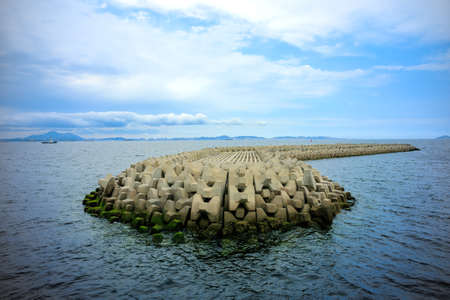 A beautiful shot of a stone breakwater in the middle of the seaの写真素材