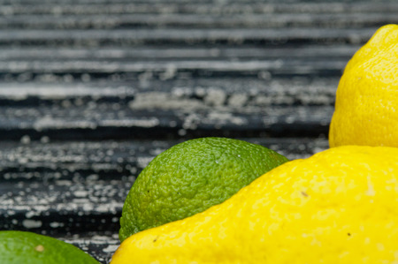 Raw textured black Background backdrop with lemon and lime and copy space outdoorの写真素材
