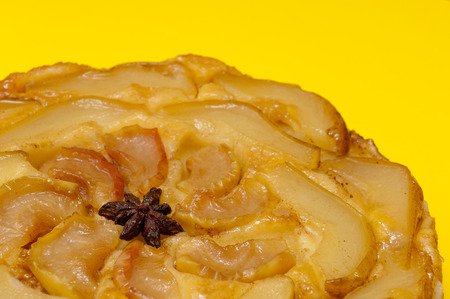 Tarte Tatin apple and pear tart pie isolated on yellow background with copy spaceの写真素材