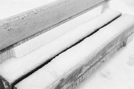 Freezing rain or sleet covered bench in a parkの写真素材