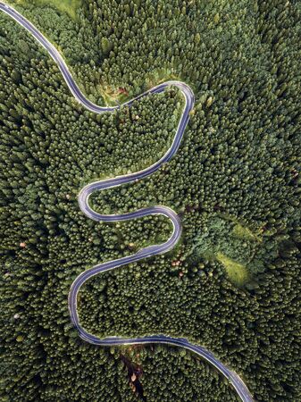 Beautiful winding road captured from above with drone at Transylvania,Romaniaの写真素材