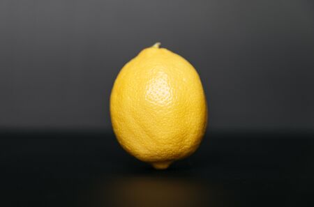 Close up of Fresh Lemon on a dark grey background.の写真素材