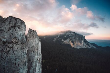 Beautiful summer sunrise in mountains,with illuminated peaks. Hasmas,Romaniaの写真素材