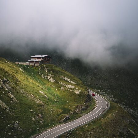 Car Traveling On Mountain In Clouds,Transfagarasan,Romaniaの写真素材