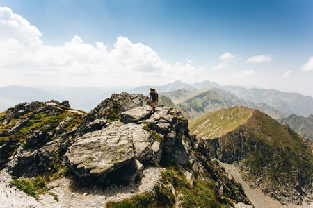Hiker on the top of the mountain in the Fagaras Mountains,Romania.の写真素材