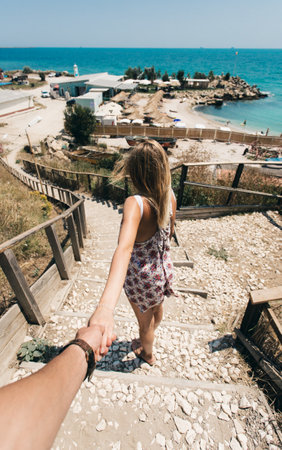 Couple in love on the beach. Man holding woman's handの写真素材