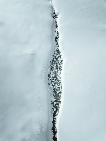 Snowy road in the mountains. Winter landscape. View from above.の写真素材