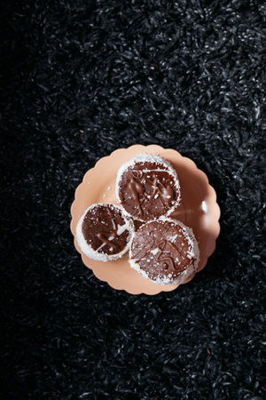 Chocolate shortbread cookies on a plate on a black background.の写真素材