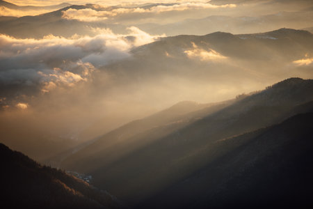 Beautiful sunrise in the mountains. Landscape with fog and sunlight. Ceahlau,Romania.の写真素材