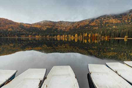 Boat on the lake in the autumn forest. Beautiful autumn landscape. autumn nature backgroundの写真素材