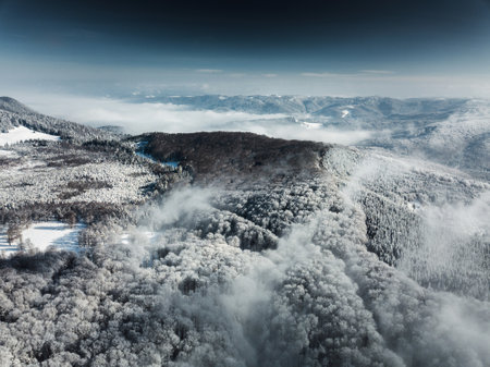 Aerial view of winter mountains covered with hoarfrost and snow.の写真素材