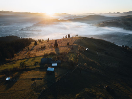 Aerial view of foggy valley in Carpathian mountains at sunrise. Bucegi,Romania.の写真素材