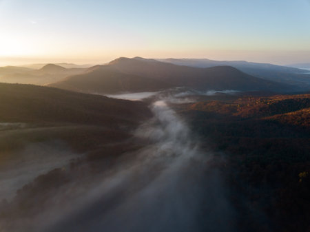 Aerial view of foggy morning in the mountains. Beautiful autumn landscape.の写真素材