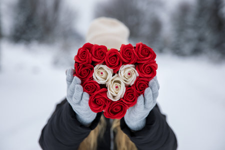Girl holding heart in winter outdoors. Romantic, Valentine's day concept.の写真素材
