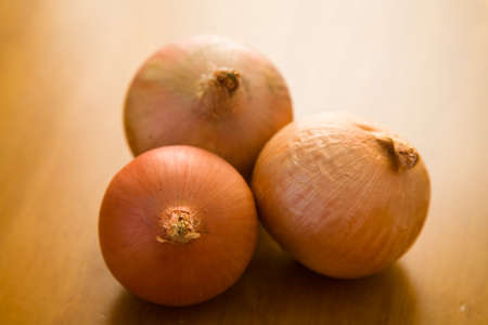 onions over wooden tableの写真素材
