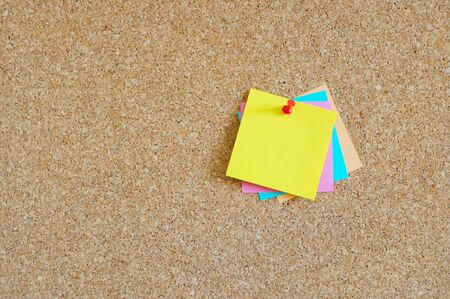 Cork board with colorful post-itの写真素材