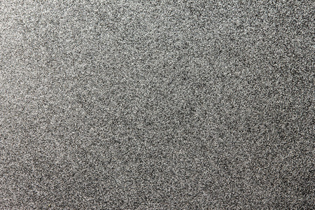 Abstract closeup of white spray paint on black paper.の写真素材