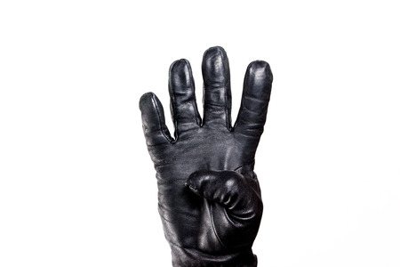 Showing fingers hand in black leather glove isolated on white.の写真素材