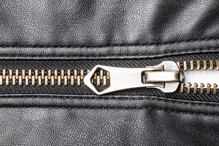 Black leather jacket zipper closeup.の写真素材