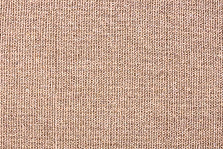 Brown fabric background. Warm color canvas texture. Bright textile material background. Closeup...