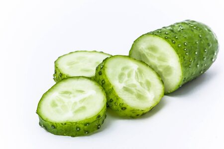 Ground cucumber slices isolated on white. Green fresh vegetable.の写真素材