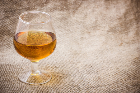 Cognac glass on linen fabric.の写真素材