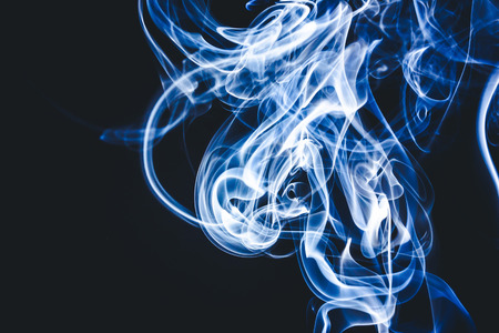 Blue smoke on black background.