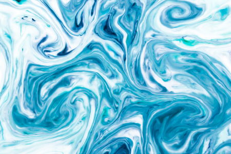 White and blue paint mixing background.の写真素材