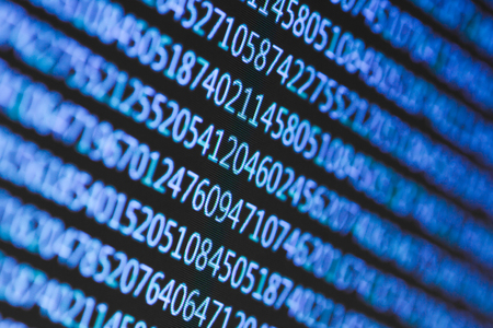 Numbers on computer screen. Macro photography with visible pixels.
