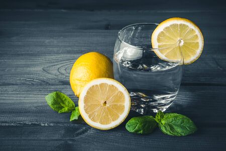 Lemon water in transparent glass with mint. Refreshing summer drink.の写真素材