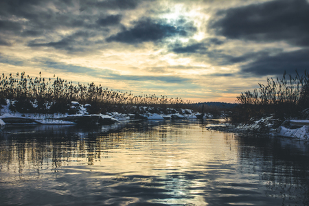 Sunset over the river during the winter. Photo taken from a boat on a river.の写真素材