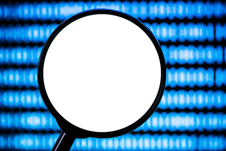 Magnifying glass with white empty copy space on blue shiny background.の写真素材