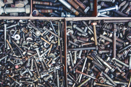 Grunge rusty metal parts like bolts, screws and nuts background.の写真素材