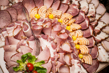 Meat slices on decorative wooden desk. Wedding catering background.の写真素材
