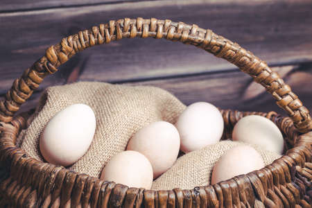 Eggs in basket vintage background.の写真素材
