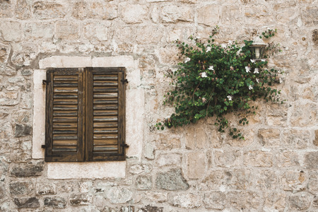 Montenegro old town rocky brick wall wooden window facade.の写真素材