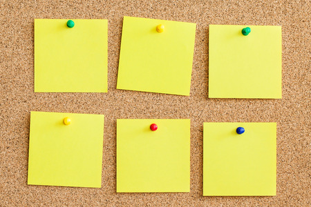 Blank empty copy space square papers background. Yellow memo reminder cards pinned to cork board.の写真素材