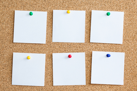 Six white memo cards reminder pinned to cork board. Blank empty copy space square papers background.の写真素材