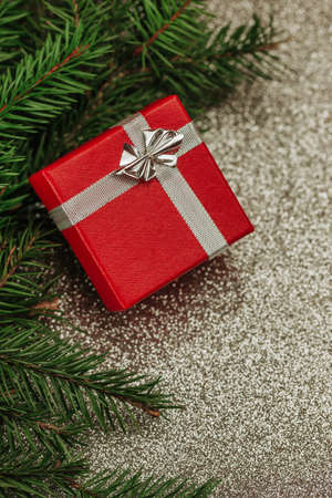 Red gift box with silver ribbon. Christmas present background.の写真素材