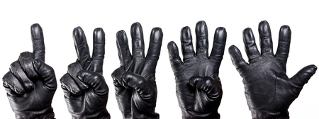 Set of five hands in black leather glove showing numbers isolated on white.の写真素材