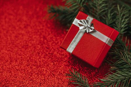 Red gift box with silver ribbon.の写真素材