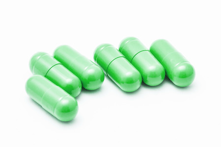 Green pills isolated on white.の写真素材
