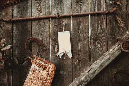 Wooden rustic wall brown paper empty copy space label on linen rope.の写真素材