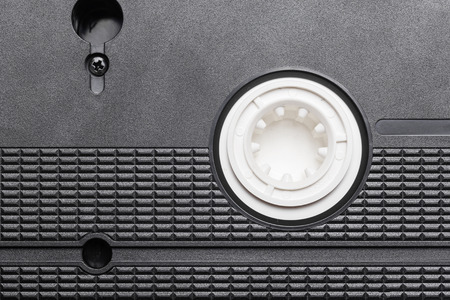Black vhs tape isolated on white. Outdated technology background.